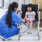 Nurse helping a child in a wheelchair - Asimily||Asimily Risk Remediation Platform - Accelerating Vulnerability Management IoMT
