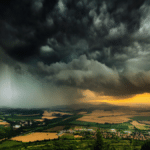 stock photo of a thunderstorm over a hilly area