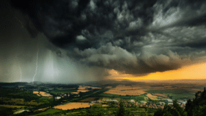 stock photo of a thunderstorm over a hilly area