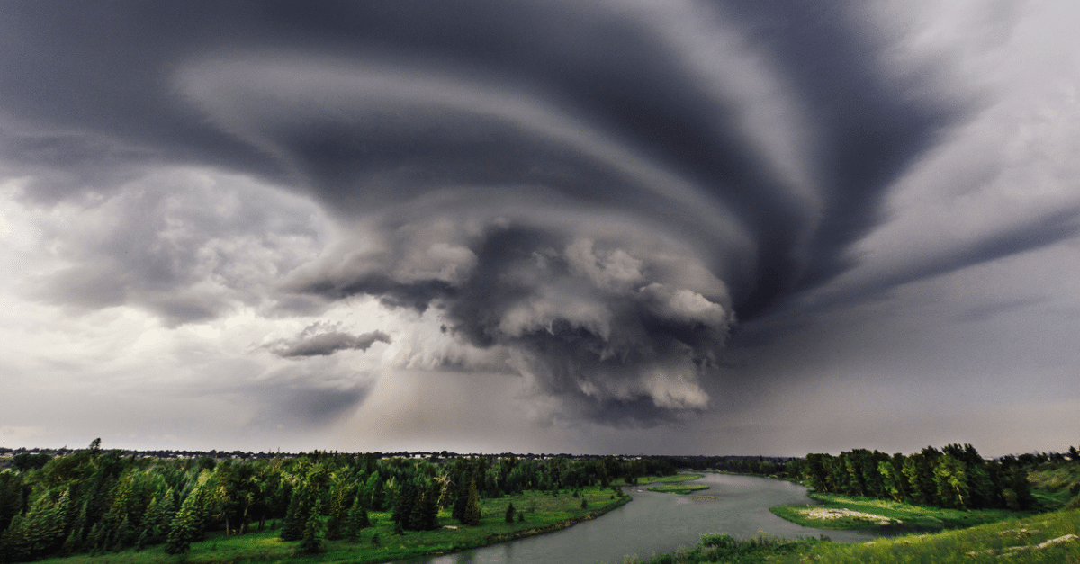 stock photo of a cyclone forming over a valley with a river