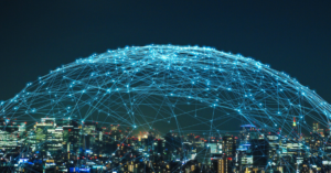 stock photo of a city with a connected web of lights over the city in a dome shape – signifying IoT security