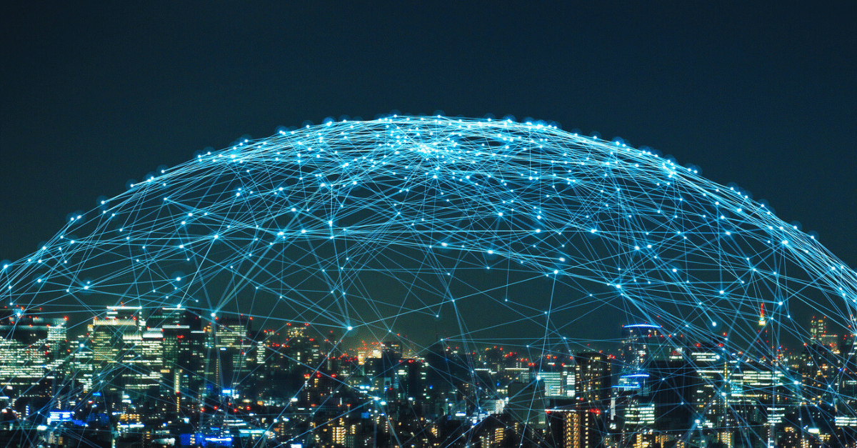 stock photo of a city with a connected web of lights over the city in a dome shape – signifying IoT security